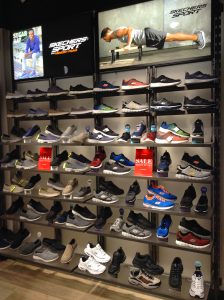 Skechers shoes displayed on glass and metal wall fixtures